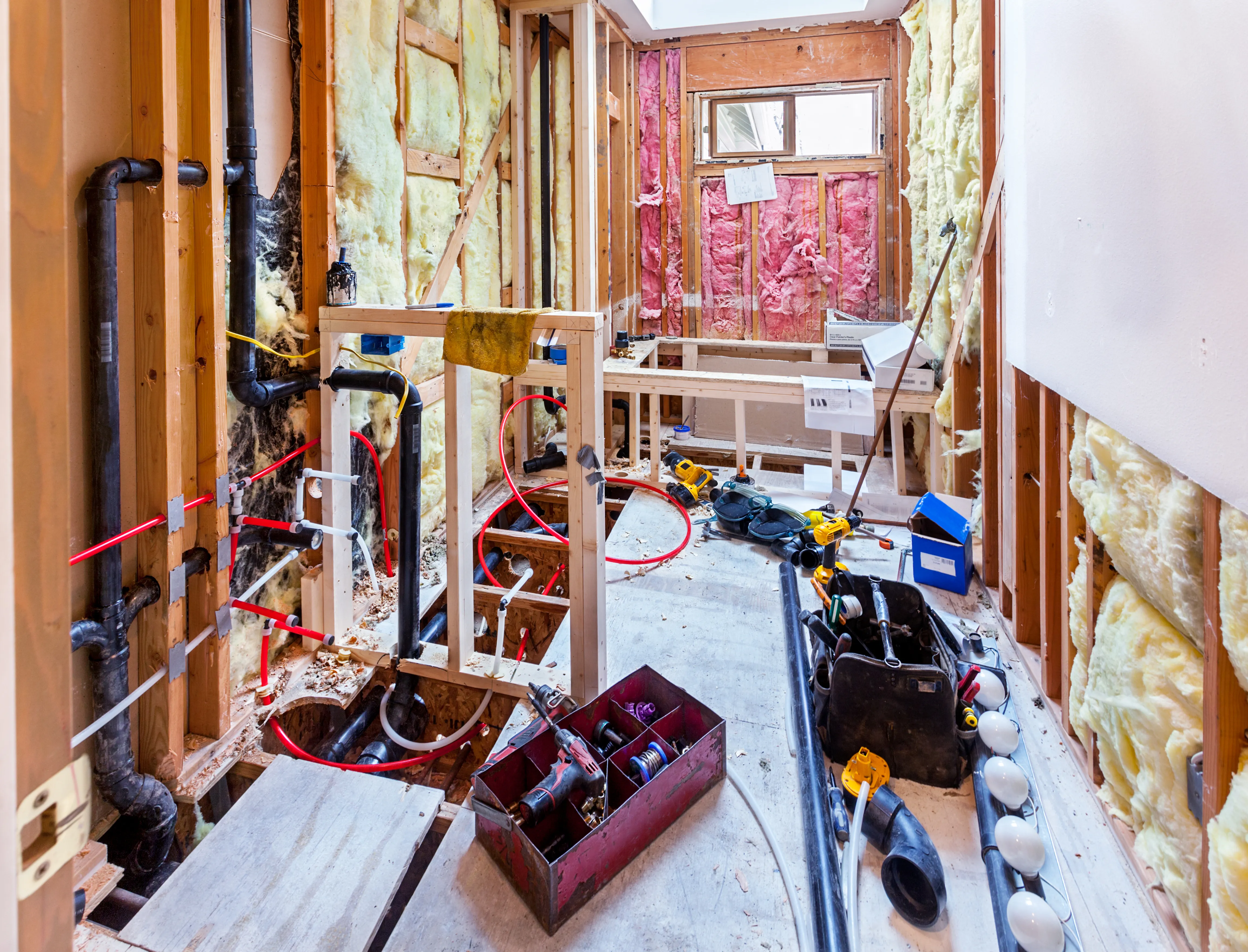 Bathroom addition under construction with new framing and plumbing in Los Angeles