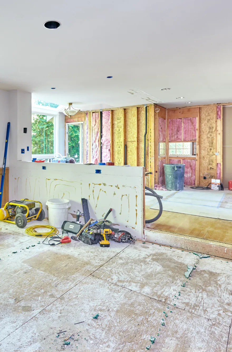 Kitchen addition under construction in Los Angeles with exposed framing, insulation, and tools during a full remodel