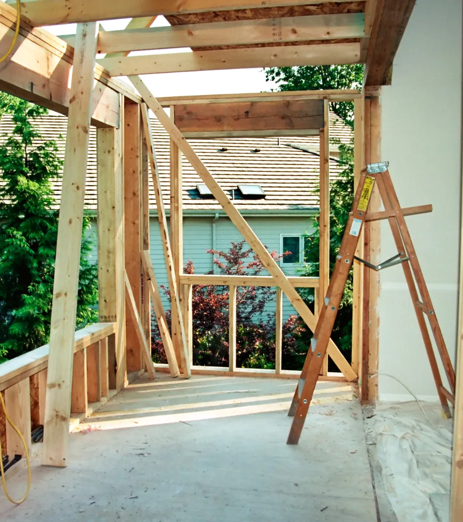 Room addition framing in progress with exposed studs and window installation for a home expansion in Los Angeles