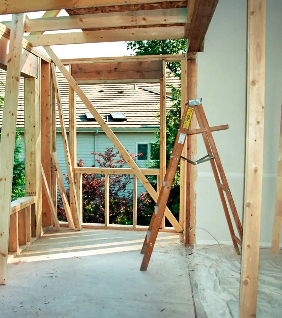 Room addition framing in progress with exposed studs and window installation for a home expansion in Los Angeles