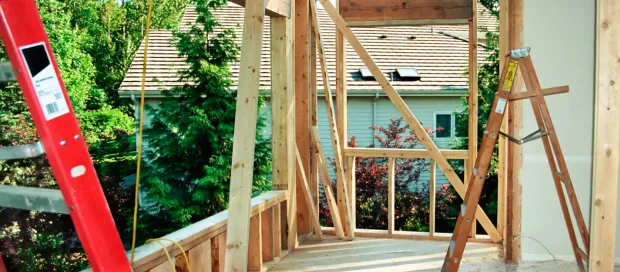 Room addition framing stage with structural wood beams