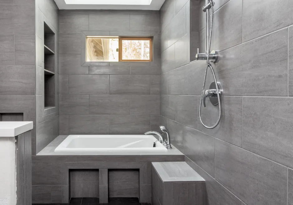 Beautifully finished modern bathroom with tile shower, built-in niches, and luxury fixtures in Los Angeles