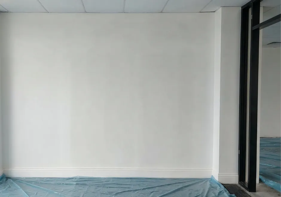 Finished commercial interior addition with completed drywall and smooth painted surfaces