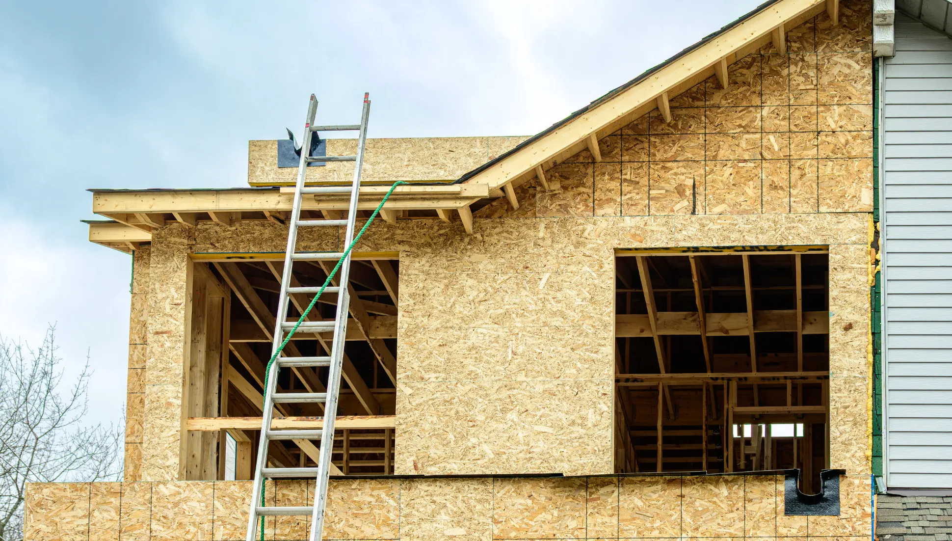 Contractor installing drywall during a room addition construction project in Los Angeles