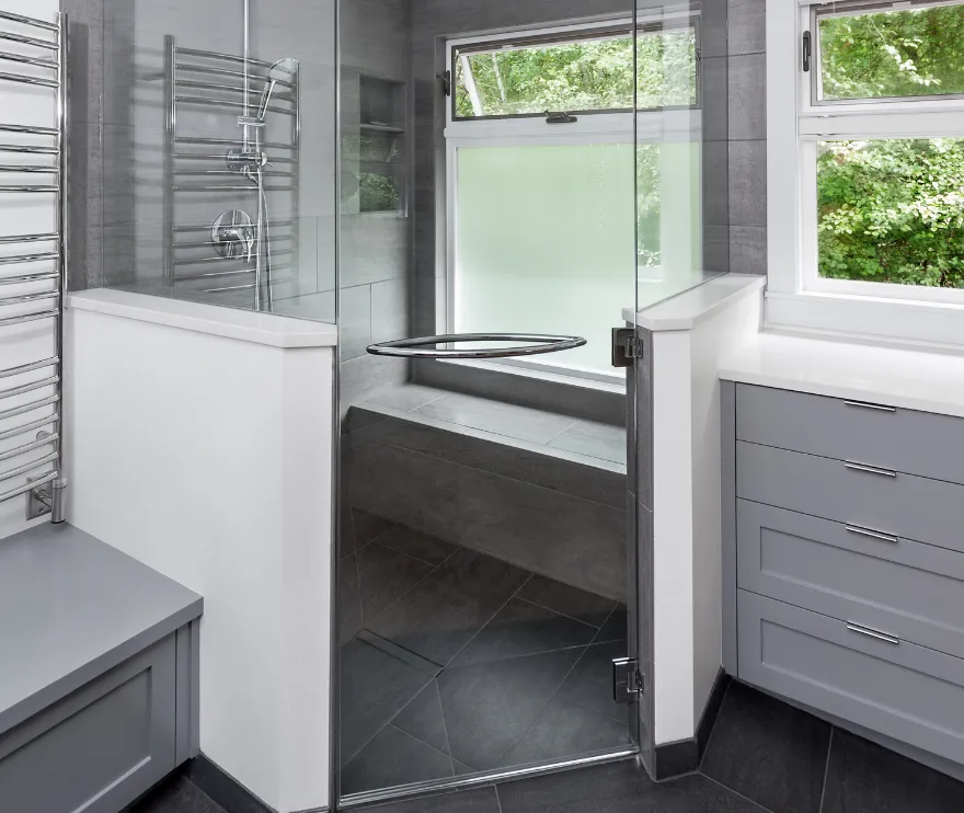 Contractor applying waterproofing and installing wall panels during bathroom addition in Los Angeles